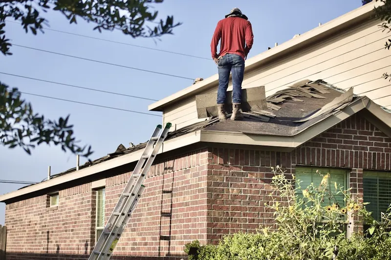 Professional roofer working on a residential roof in Westwood Hills